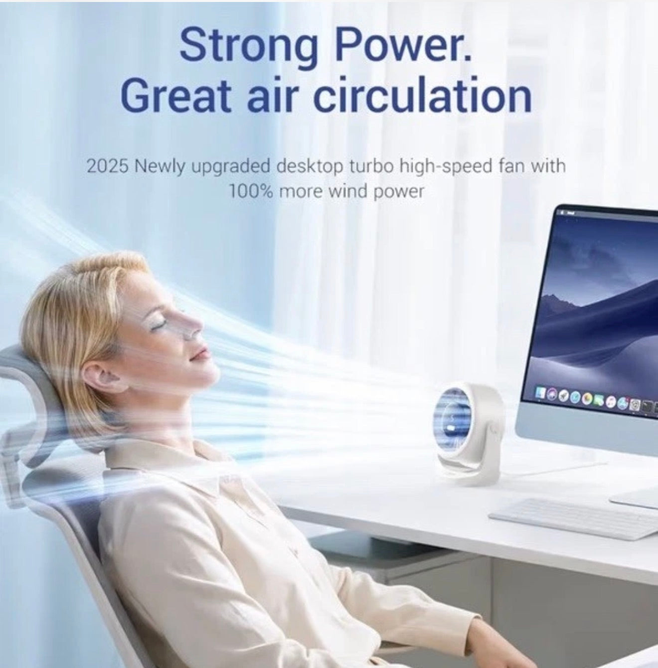 A woman reclining in an office chair beside a desk computer, with a small white desktop fan shown in front of her. Large text reads 'Strong Power.