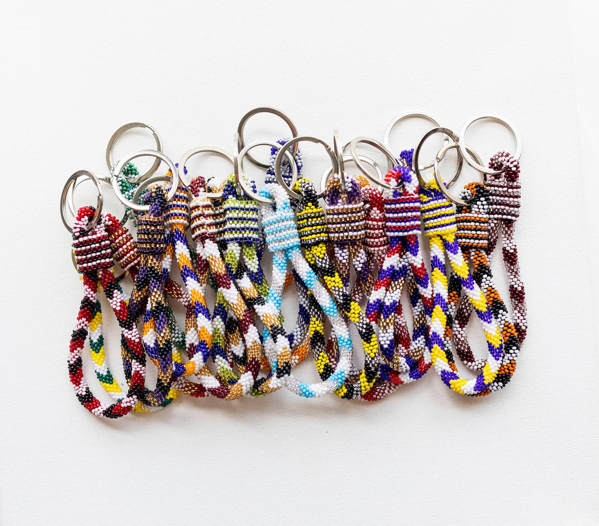 Set of colorful braided keychains on a white background