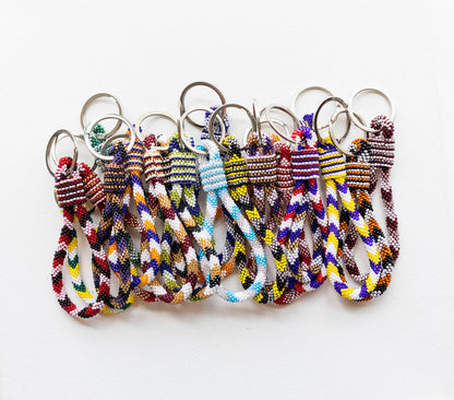 Set of colorful braided keychains on a white background