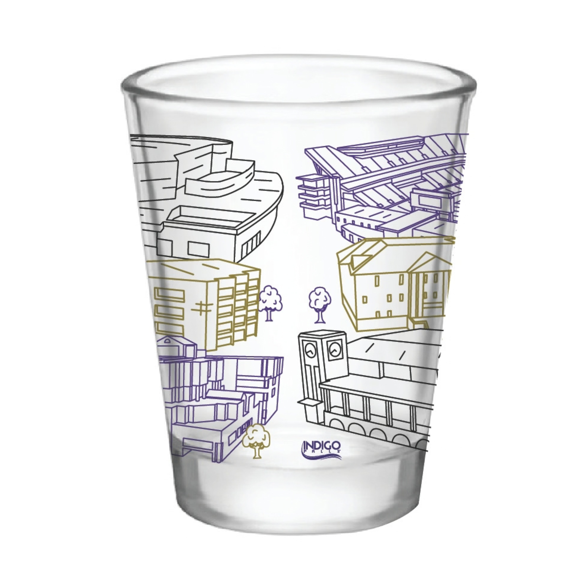 A clear glass shot glass featuring printed isometric line drawings of various buildings and structures in purple and gold, with the brand name 'INDIGA' printed near the bottom.