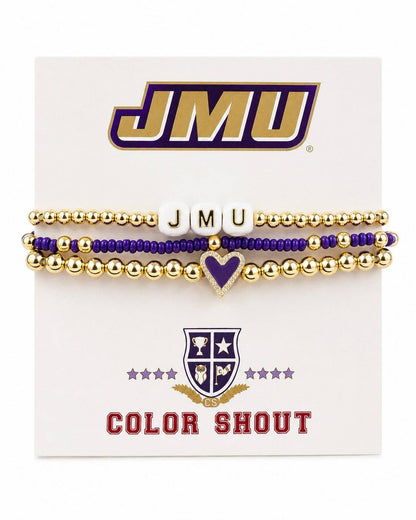 A set of three JMU 'Color Shout' beaded bracelets on a white display card. The bracelets feature gold and purple beads, white letter beads spelling 'JMU', and a purple heart charm.