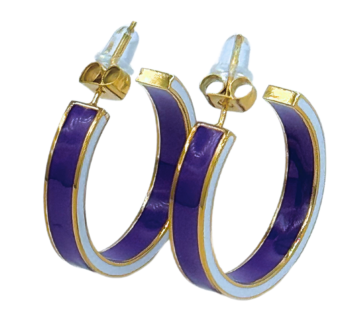 A pair of gold hoop earrings with a thick purple enamel center and a thin white enamel border, shown on a plain white background.