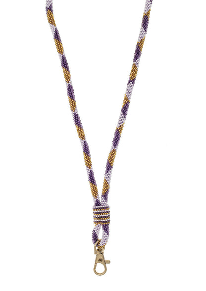 A braided woven lanyard strap in purple, gold, and white, featuring a gold metal lobster clasp at the bottom, shown against a plain white background.
