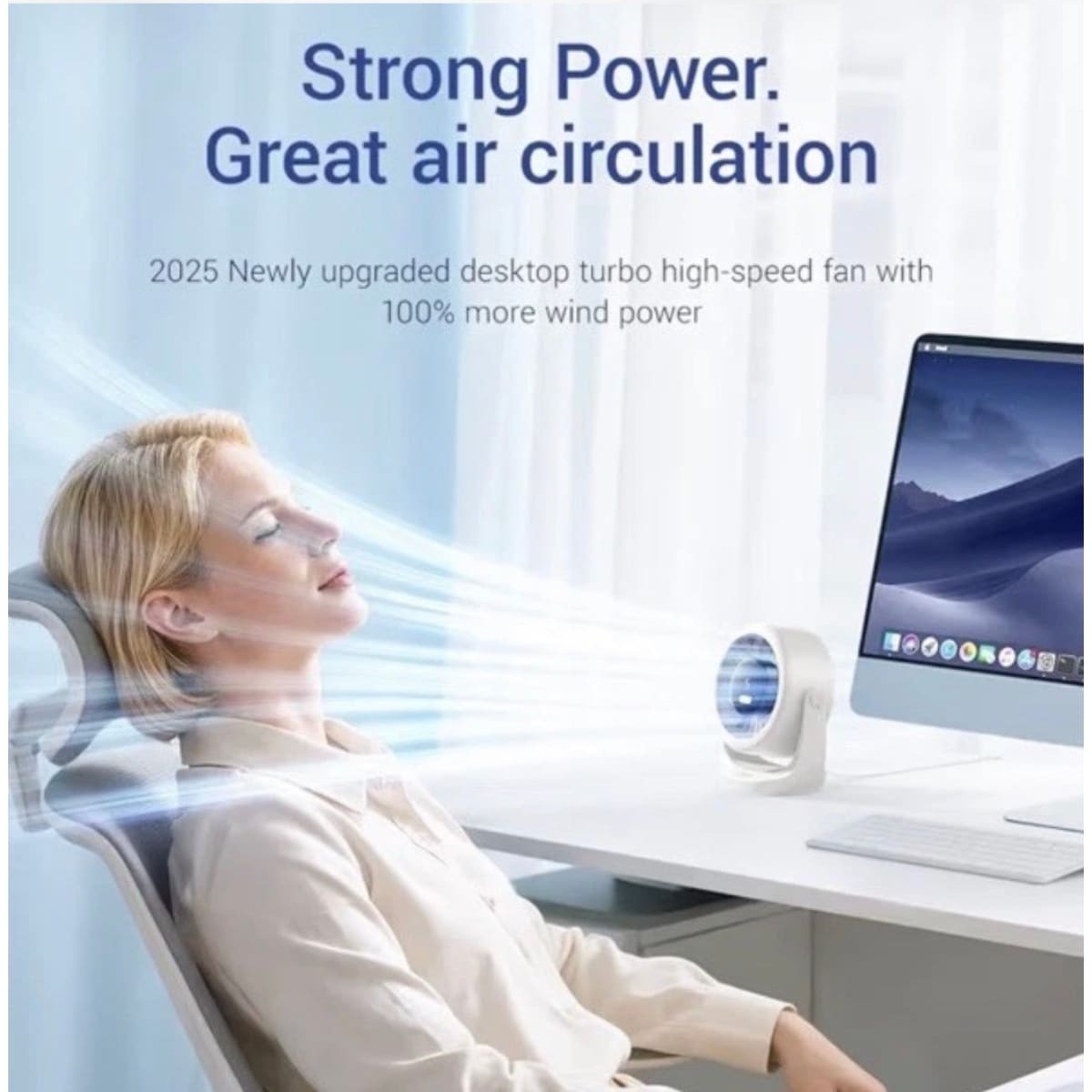 A woman reclining in an office chair beside a desk computer, with a small white desktop fan shown in front of her. Large text reads 'Strong Power.
